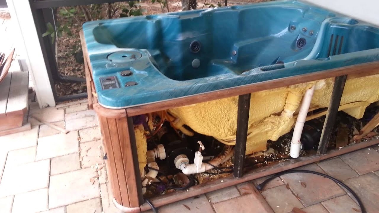 A small bird enters a colorful birdhouse.